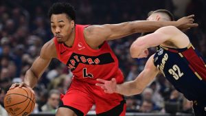 Toronto Raptors forward Scottie Barnes drives on Cleveland Cavaliers forward Dean Wade during the first half in Game 1 of a first-round NBA playoffs basketball series, Saturday, April 18, 2026, In Cleveland. (AP Photo/David Dermer)