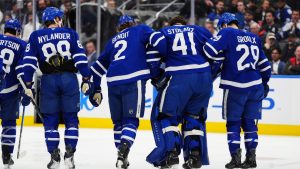 Toronto Maple Leafs goaltender Anthony Stolarz (41) is helped off the ice by teammates following an injury against the Washington Capitals during first period NHL hockey action in Toronto on Wednesday, April 8, 2026. THE CANADIAN PRESS/Frank Gunn