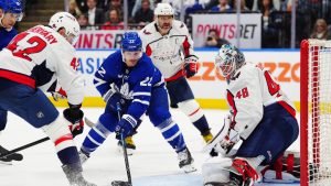 Washington Capitals' goaltender Logan Thompson (48) makes a save as Toronto Maple Leafs' Jake McCabe (22) and Capitals' Martin Fehervary (42) look for the puck during second period NHL hockey action in Toronto on Wednesday, April 8, 2026. THE CANADIAN PRESS/Frank Gunn