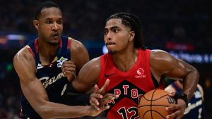 Toronto Raptors forward Collin Murray-Boyles drives on Cleveland Cavaliers center Evan Mobley during the first half in Game 1 of a first-round NBA playoffs basketball series, Saturday, April 18, 2026, In Cleveland. (AP Photo/David Dermer)