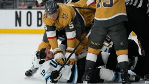 Vegas Golden Knights defenceman Jeremy Lauzon (5) and Utah Mammoth left wing Brandon Tanev (13) fight during the first period in Game 1 of a first-round NHL hockey Stanley Cup playoff series Sunday, April 19, 2026, in Las Vegas. (John Locher/AP)