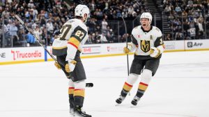 Vegas Golden Knights Brayden McNabb, right, celebrates with Shea Theodore, left, who scored the winning goal during the overtime period of Game 4 of a first-round NHL hockey Stanley Cup playoff series against the Utah Mammoth, Monday, April 27, 2026, in Salt Lake City. (Tyler Tate/AP)
