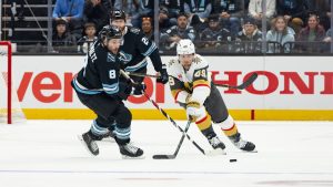 Vegas Golden Knights left wing Ivan Barbashev (49) goes after the puck against Utah Mammoth center Nick Schmaltz (8) during the first period of Game 3 of the first round in an NHL hockey Stanley Cup playoff series, Friday, April 24, 2026, in Salt Lake City. (Melissa Majchrzak/AP)