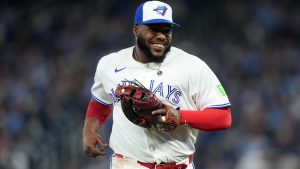 Toronto Blue Jays first baseman Vladimir Guerrero Jr. (27) smiles while running back to the dugout after the inning during third inning MLB baseball action in Toronto on Friday, March 27, 2026. (Nathan Denette/CP)