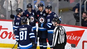 Winnipeg Jets' Gabriel Vilardi (13) celebrates his goal against the Seattle Kraken with Mark Scheifele (55), Josh Morrissey (44), Jonathan Toews (19) and Kyle Connor (81) during second period NHL hockey action in Winnipeg, Monday, April 6, 2026. (Fred Greenslade/CP)