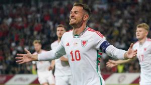 Wales' Aaron Ramsey celebrates after scoring his side's opening goal during the Euro 2024 group D qualifying soccer match between Latvia and Wales. (Roman Koksarov/AP)