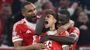 Bayern's Luis Diaz, centre, celebrates with Dayot Upamecano and Jonathan Tah after scoring his their third goal during the Champions League quarterfinal second leg soccer match between Bayern Munich and Real Madrid in Munich, Germany, Wednesday, April 15, 2026. (Sven Hoppe/dpa via AP)
