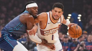 Phoenix Suns guard Devin Booker, right, drives past Oklahoma City Thunder guard Luguentz Dort during the first half in Game 2 of a first-round NBA playoffs basketball series Wednesday, April 22, 2026, in Oklahoma City. (Kyle Phillips/AP)