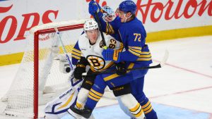 Boston Bruins center Fraser Minten (93) and Buffalo Sabres center Tage Thompson (72) battle for position during the third period of an NHL hockey game Wednesday, March 25, 2026, in Buffalo, N.Y. (Jeffrey T. Barnes/AP)