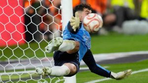 Real Sociedad's goalkeeper Unai Marrero makes a save during during the penalty shoot out at the Copa del Rey final soccer match between Atletico Madrid and Real Sociedad in Seville, Spain, Saturday, April. 18, 2026. (Jose Breton/AP)