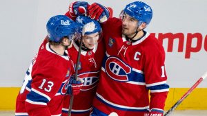 Montreal Canadiens' Cole Caufield (13), Lane Hutson (48) and Nick Suzuki (14) celebrate their game-tying goal against the Florida Panthers during third period NHL hockey action in Montreal on Tuesday, April 7, 2026. (Christinne Muschi/CP)