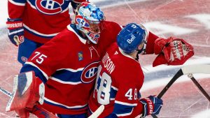 Montreal Canadiens goaltender Jakub Dobes (75) congratulates teammate Lane Hutson (48) on his game-winning goal against the Tampa Bay Lightning following overtime NHL playoff hockey action. (Christinne Muschi/THE CANADIAN PRESS)