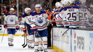 Edmonton Oilers centre Connor McDavid, centre, is congratulated by teammates after scoring during the third period of Game 3 in the first round of the NHL hockey Stanley Cup playoffs series against the Anaheim Ducks, Friday, April 24, 2026, in Anaheim, Calif. (Mark J. Terrill/AP)