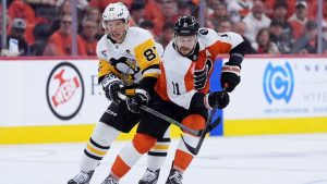 Philadelphia Flyers' Travis Konecny, right, tries to keep the puck away from Pittsburgh Penguins' Sidney Crosby during the second period of Game 3 in the first round of the NHL Stanley Cup hockey playoffs Wednesday, April 22, 2026, in Philadelphia. (Matt Slocum/AP Photo)