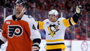 Pittsburgh Penguins' Sidney Crosby, right, reacts behind Philadelphia Flyers' Luke Glendening after scoring during the first period of Game 4 in the first round of the NHL Stanley Cup hockey playoff series Saturday, April 25, 2026, in Philadelphia. (Matt Slocum/AP)