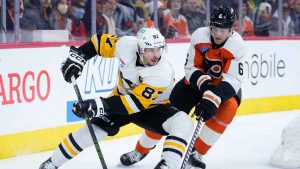 Pittsburgh Penguins' Sidney Crosby, left, tries to get past Philadelphia Flyers' Travis Sanheim during the third period of an NHL hockey game. (Matt Slocum/AP)