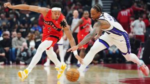 Toronto Raptors' Scottie Barnes (4) and Sacramento Kings' DeMar DeRozan (10) battle for the ball during first half NBA basketball action in Toronto on Wednesday, April 1, 2026. (Frank Gunn/CP)