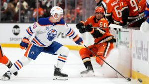 Anaheim Ducks defenseman Tyson Hinds, right, passes the puck while under pressure from Edmonton Oilers defenseman Ty Emberson during the first period of Game 3 in the first round of the NHL hockey Stanley Cup playoffs series Friday, April 24, 2026, in Anaheim, Calif. (Mark J. Terrill/AP)