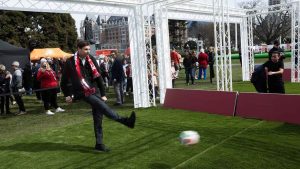 Premier David Eby takes a shot on net at one of the interactive centres on the grounds of the legislature during the FIFA World Cup 2026 countdown celebration event in Victoria, B.C. (Chad Hipolito/THE CANADIAN PRESS)
