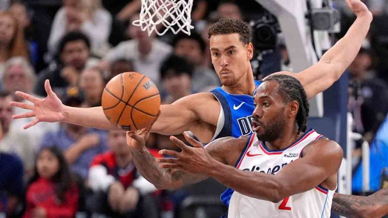 Los Angeles Clippers forward Kawhi Leonard, right, passes the ball as Dallas Mavericks forward Dwight Powell defends during the first half of an NBA basketball game Tuesday, April 7, 2026, in Inglewood, Calif. (Mark J. Terrill/AP)