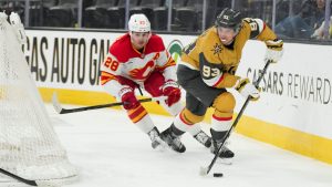 Vegas Golden Knights right wing Mitch Marner (93) skates with the puck against Calgary Flames defenseman Zach Whitecloud (28) during the second period of an NHL hockey game Thursday, April 2, 2026, in Las Vegas. (Candice Ward/AP)