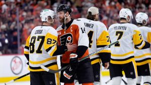 Philadelphia Flyers' Sean Couturier (14) and Pittsburgh Penguins' Sidney Crosby (87) meet after the Flyers won Game 6 in the first round of the NHL hockey Stanley Cup playoffs series Wednesday, April 29, 2026, in Philadelphia. (Matt Slocum/AP)