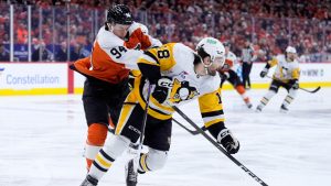 Philadelphia Flyers' Porter Martone, left, collides with Pittsburgh Penguins' Tommy Novak during the first period of Game 4 in the first round of the NHL Stanley Cup hockey playoffs Saturday, April 25, 2026, in Philadelphia. (Matt Slocum/AP)
