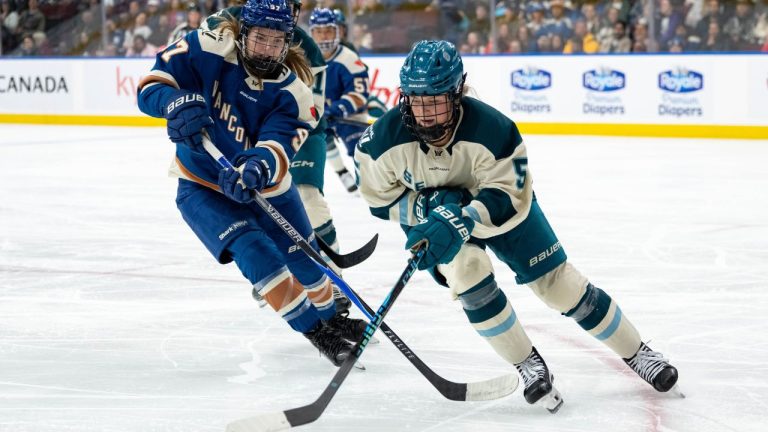 Vancouver Goldeneyes' Anna Shokhina (97) and Seattle Torrent's Anna Wilgren (5) vie for the puck during the third period of a PWHL hockey game in Vancouver, on Tuesday, April 14, 2026. (Ethan Cairns/THE CANADIAN PRESS)