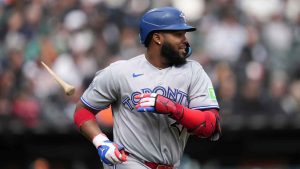 Toronto Blue Jays' Vladimir Guerrero Jr. (27) tosses a piece of broken bat after hitting a single during the sixth inning of a home-opener baseball game against the Chicago White Sox. (Erin Hooley/AP)