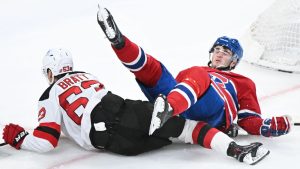 New Jersey Devils' Jesper Bratt (63) collides with Montreal Canadiens' Noah Dobson during second period NHL hockey action in Montreal, Sunday, April 5, 2026. (Graham Hughes/CP)