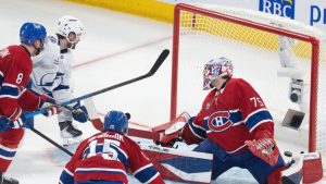 Tampa Bay Lightning's Brandon Hagel scores on Montreal Canadiens goaltender Jakub Dobes as Canadiens' Mike Matheson and Alex Newhook defend during third period NHL playoff action in Montreal on Sunday, April 26, 2026. (THE CANADIAN PRESS/Christinne Muschi)