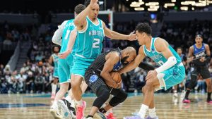 Orlando Magic guard Jevon Carter, center, battles for the ball with Charlotte Hornets forward Grant Williams, left, and guard Josh Green, right, during the first half of an NBA basketball game, Thursday, March 19, 2026, in Charlotte, N.C. (Matt Kelley/AP)