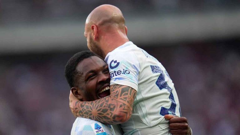 Inter Milan's Marcus Thuram, left, celebrates with teammate Federico Dimarco after scoring his side's opening goal during a Serie A soccer match between Torino and Inter Milan. (Spada/AP)