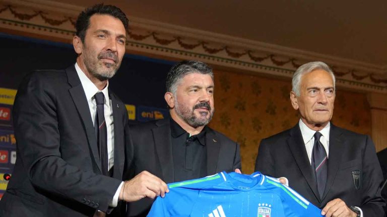 Newly appointed Italian national soccer team head coach Rino Gattuso, center, poses for photographers with Italian Soccer Federation, FGCI, president Gabriel Gravina, right, and former player Gianluigi Buffon as he arrives for a press conference. (Alessandra Tarantino/AP)