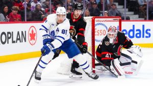 Toronto Maple Leafs' John Tavares (91) and Ottawa Senators' Lars Eller (89) battle for the puck as goaltender James Reimer (47) keeps an eye on it during first period NHL hockey action in Ottawa on Wednesday, April 15, 2026. (Sean Kilpatrick/CP)