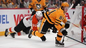 Pittsburgh Penguins' Ben Kindel (81) wins a battle for the puck with Philadelphia Flyers' Rasmus Ristolainen (55) defending during the second period of Game 1 in the first round of the NHL Stanley Cup playoffs in Pittsburgh, Saturday, April 18, 2026. (Gene J. Puskar/AP)
