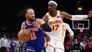 New York Knicks guard Jalen Brunson (11) dribbles against Atlanta Hawks forward Onyeka Okongwu (17) on the final possession during the second half in Game 3 of a first-round NBA playoffs basketball series, Thursday, April 23, 2026, in Atlanta. (Colin Hubbard/AP Photo)