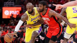 Los Angeles Lakers forward LeBron James, left, attempts to keep the ball as he drives around Houston Rockets forward Tari Eason during the first half in Game 3 of a first-round NBA playoffs basketball series Friday April 24, 2026, in Houston. (Michael Wyke/AP)
