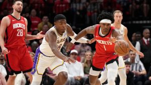 Houston Rockets guard Amen Thompson (1) reaches for the ball against Los Angeles Lakers forward Rui Hachimura, left, during the first half in Game 4 of a first-round NBA basketball playoffs series, Sunday, April 26, 2026, in Houston. (Karen Warren/AP)