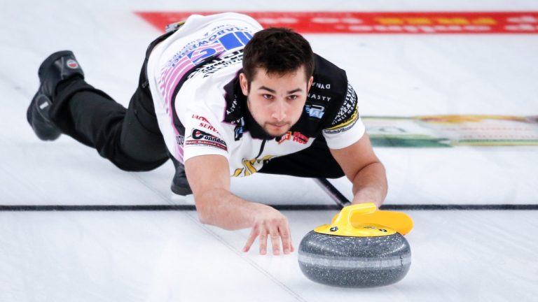 Team Sahaidak/Lott third Colton Lott makes a shot while playing Team Einarson/Gushue during the Canadian Mixed Doubles Curling Championship final in Calgary, Alta., Thursday, March 25, 2021.THE CANADIAN PRESS/Jeff McIntosh