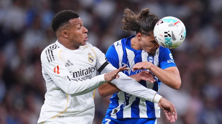 Real Madrid's Kylian Mbappe, left, and Alaves' Youssef Enriquez fight for the ball during a La Liga soccer match between Real Madrid and Alaves in Madrid, Spain, Tuesday, April 21, 2026. (Manu Fernandez/AP Photo)