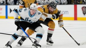 Utah Mammoth centre Logan Cooley (92) skates around Vegas Golden Knights defenceman Rasmus Andersson, right, during the first period of an NHL hockey game Thursday, March 19, 2026, in Las Vegas. (John Locher/AP)