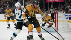 Utah Mammoth center Barrett Hayton (27) and Vegas Golden Knights center Nic Dowd (26) vie for the puck during the first period of Game 5 of a first-round NHL hockey Stanley Cup playoff series Wednesday, April 29, 2026, in Las Vegas. (John Locher/AP)