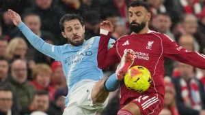Manchester City's Bernardo Silva, left, and Liverpool's Mohamed Salah fight for the ball during the English Premier League soccer match between Liverpool and Manchester City. (Jon Super/AP)