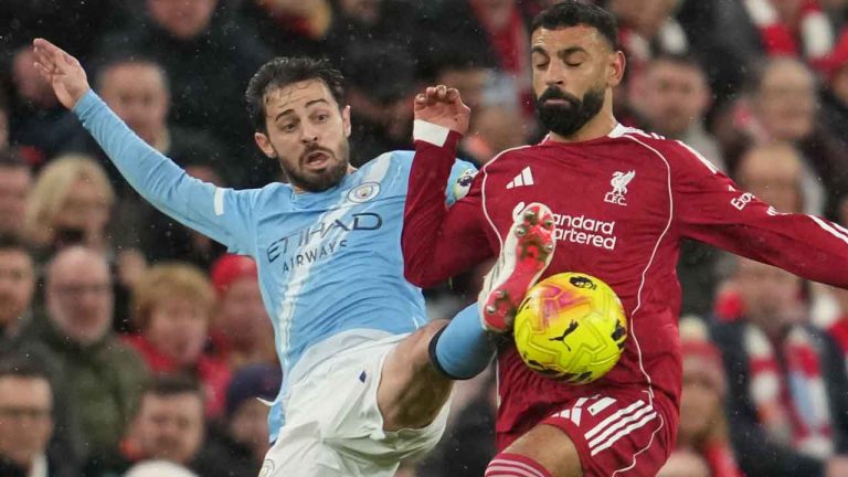 Manchester City's Bernardo Silva, left, and Liverpool's Mohamed Salah fight for the ball during the English Premier League soccer match between Liverpool and Manchester City. (Jon Super/AP)