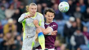 Manchester City's Erling Haaland, left, and Burnley's Hjalmar Ekdal fight for the ball during the Premier League soccer match between Burnley and Manchester City in Burnley, England, Wednesday, April 22, 2026. (Dave Thompson/AP Photo)