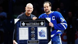 Former Toronto Maple Leafs player Mats Sundin, left, presents Auston Matthews (34) with artwork to recognize him on becoming the all-time franchise leader in goals prior to first period NHL hockey action against the Florida Panthers in Toronto on Tuesday, Jan. 6, 2026. (Frank Gunn/CP)