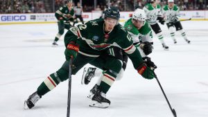 Minnesota Wild left wing Matt Boldy, left, skates with the puck alongside Dallas Stars defenseman Miro Heiskanen (4) during the third period of Game 4 in the first round of the NHL Stanley Cup hockey playoffs Saturday, April 25, 2026, in St. Paul, Minn. (Matt Krohn/AP)