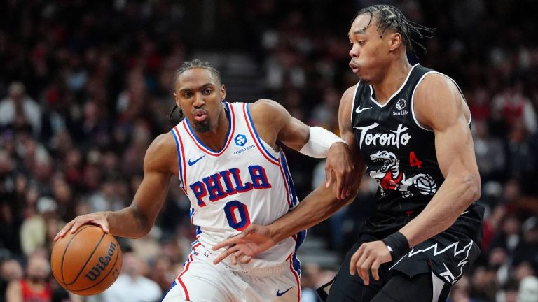 Philadelphia 76ers guard Tyrese Maxey (0) moves the ball past Toronto Raptors forward/guard Scottie Barnes (4) during second half NBA basketball action in Toronto, Monday, Jan. 12, 2026. (Frank Gunn/CP)