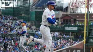 Chicago Cubs' Nico Hoerner, foreground, walks to first during the first inning of a baseball game against the New York Mets in Chicago, Sunday, April 19, 2026. (Nam Y. Huh/AP)